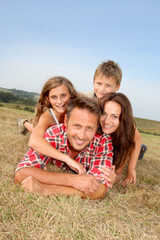 Closeup of happy family lying in grass