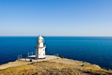 Fototapeta na wymiar beautiful white lighthouse on a meganom krimea ukraine