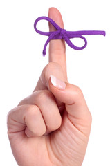 A finger contains a bow-tied string as a reminder - 26321161