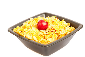 cherry in a bowl with cornflakes isolated on white