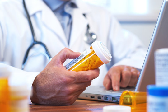 Doctor preparing online internet prescription