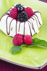 Black and White chocolate with blackberries on green plate