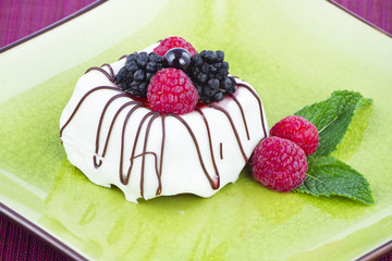 Black and White chocolate with blackberries on green plate