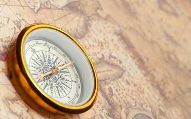Fototapeta na wymiar Old compass on ancient map