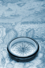 Old compass on ancient map