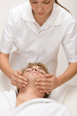 Obraz na płótnie Canvas Male beauty - man receiving facial massage