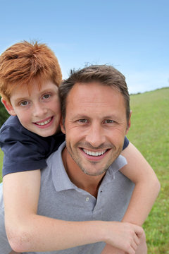 Closeup of father and son in countryside