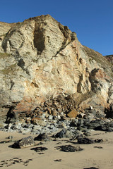 Large eroding cliffs in Porthtowan with fallen rocks.