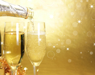 Champagne glasses on golden background