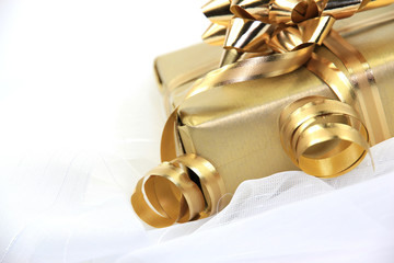 Golden gift on white cloth