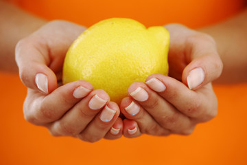 lemon in woman hands