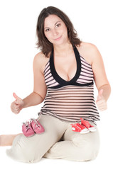 Portrait of pretty pregnant woman baby shoes