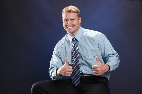 Young Businessman In Teal Shirt On Blue