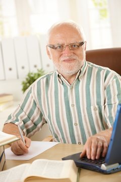 Senior professor working in his study