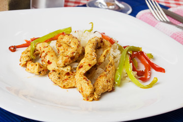 Spicy chicken meat with rice and bell pepper