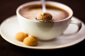 Cup of delicious coffee with biscotti