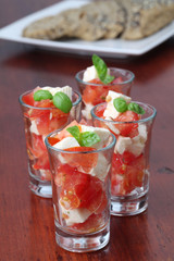 Fototapeta na wymiar Caprese appetizers with tomatoes, mozzarella and basil