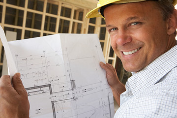 Architect With Plans In New Home