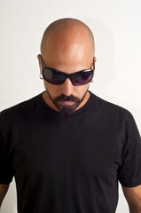 Fototapeta premium man with glasses blacks, black coat and beard, bouncer bodyguard