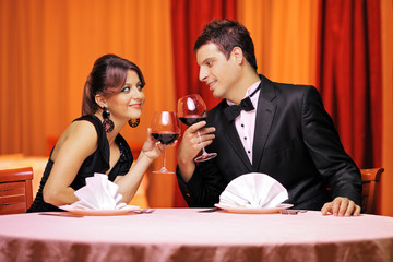 View of a young couple in love drinking red wine in a restaurant