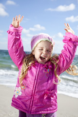 Cute young girl having fun on the beach