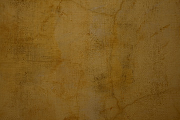 Honey colored cracked plaster wall