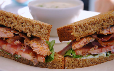 Grilled salmon sandwich on pumpernickel bread