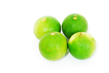four limes isolated on seamless white background