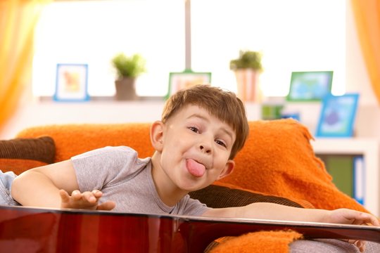 Five year old boy putting out tongue for pose
