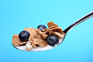 Cereal with blueberries on spoon
