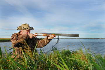 Hunter aims his gun