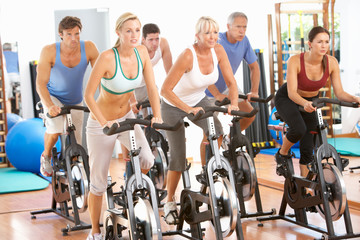 Group Of People In Spinning Class In Gym