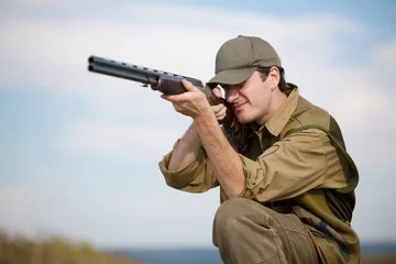 Fotobehang Hunter aiming at the hunt during a hunting party © NanoStock