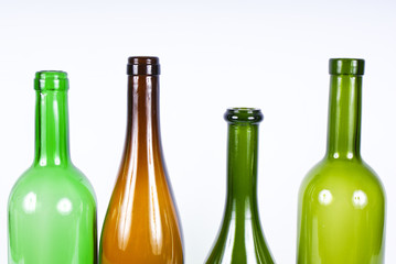 Four colored bottles on a white background.