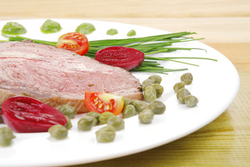 barbecue on white dish over wood