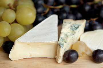 Three types of cheese and fresh grapes