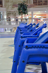 Baby chairs in line in shopping mall
