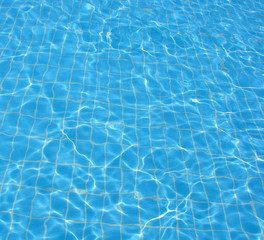 Fototapeta na wymiar bottom and water in blue transparent pool