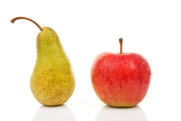 Juicy pear and red apple with water drops over white background