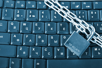 laptop keyboard secured with chain and padlock.