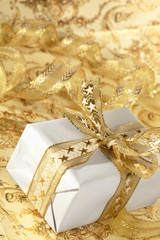 Beautiful gift box on the gold background