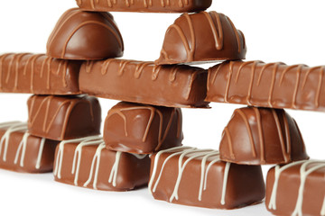 many chocolate appetizing candys with icing pyramid figure