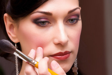 Fototapeta premium closeup brunette young lady bride get ready for the event by mak