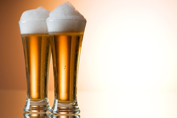 Beer glasses against the colorful gradient background