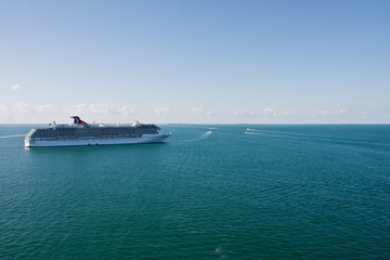 Small Boats Circling Cruise Ship on Green Water