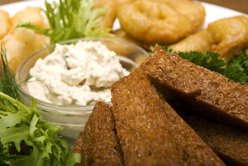 Appetizer made of fried onion, potato and bread
