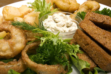 Appetizer made of fried onion, potato and bread