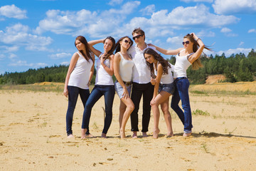 Group of six friends all in blue jeans and white
