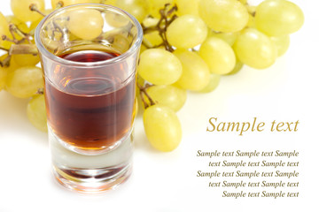 alcoholic drink in tumbler and grapes