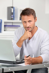 Closeup of employee in the office working on laptop computer